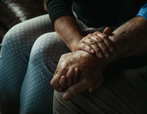 Younger adult holding an older adults arm.